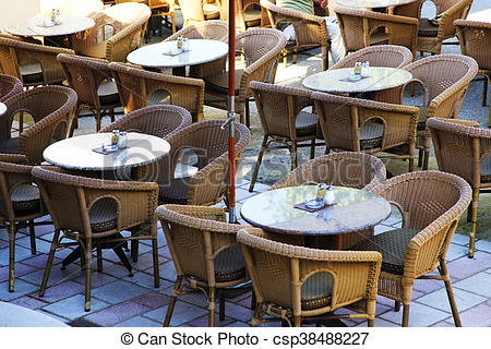 Cafe with tables and chairs. Street view of a cafe terrace with .